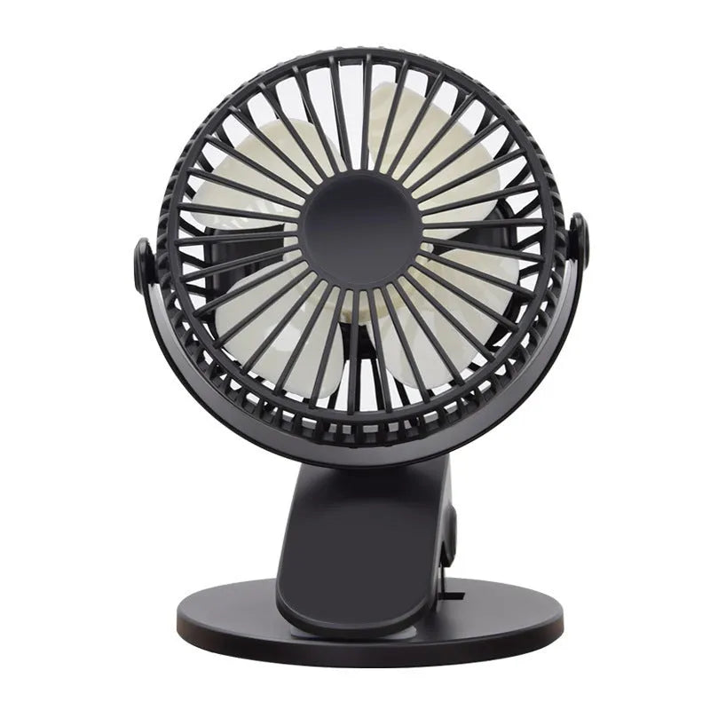 Small white clip fan with plastic blades attached to a surface, showing USB cable and piano button switch.