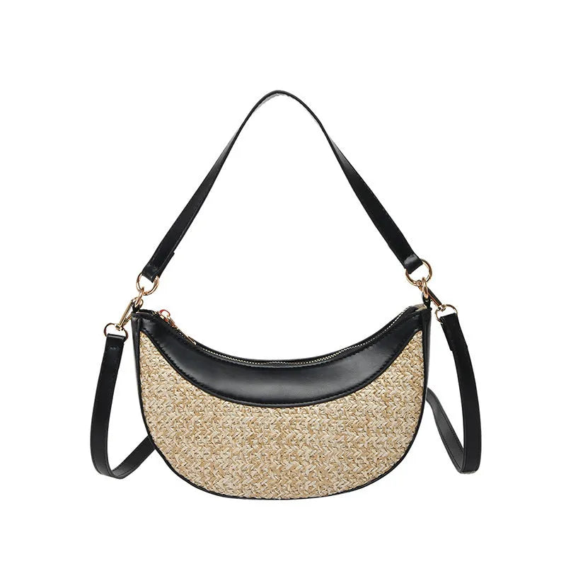 Straw crossbody dumpling bag in a hard suitcase shape with a single shoulder strap.