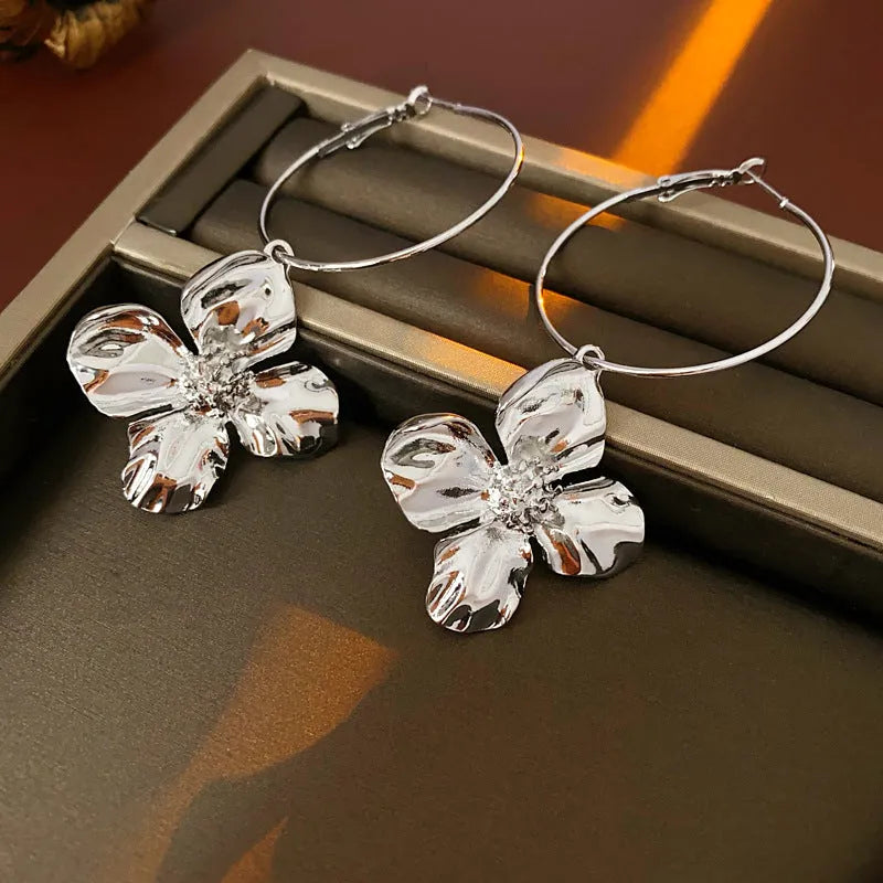 Silver needle metal flower earrings with geometric floral design in gold or silver colour