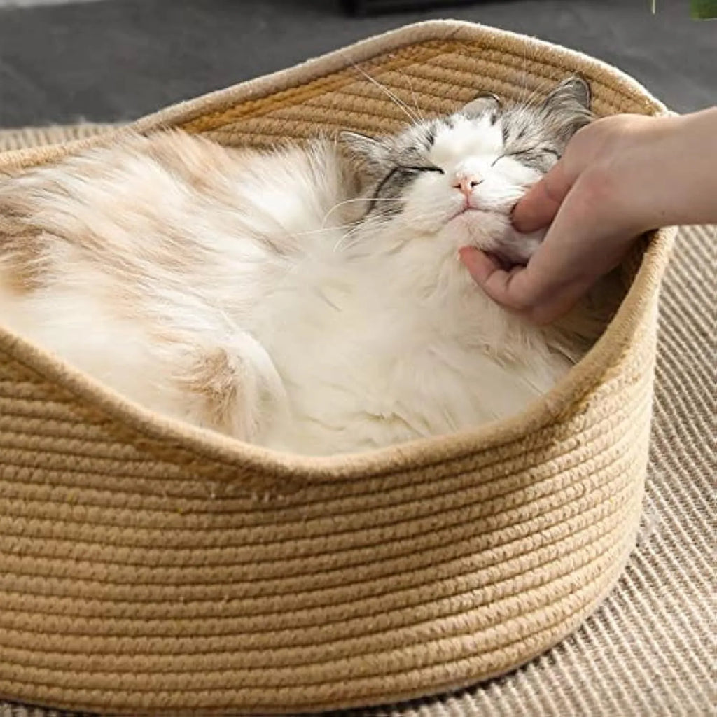 A square wicker cat bed basket with an integrated corrugated cardboard scratching panel on one side.