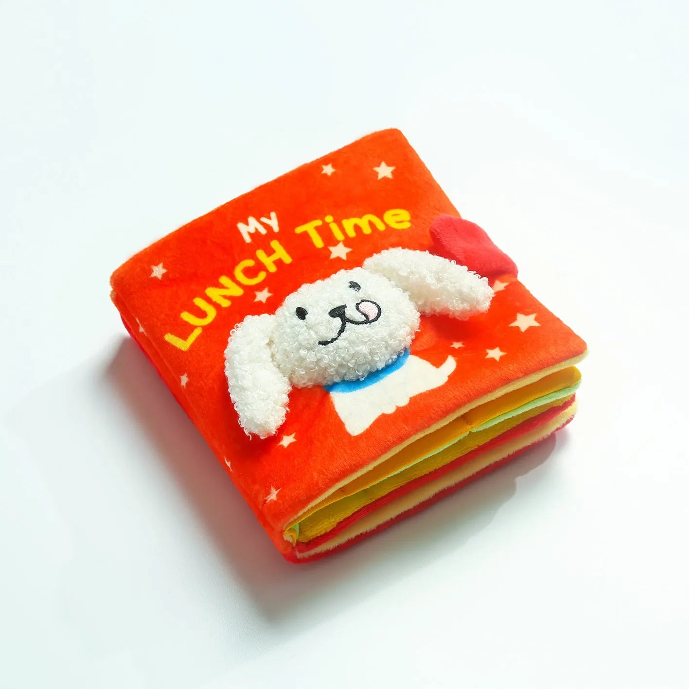 Red book shaped plush pet toy with hidden food compartment and squeaky sound for dogs and cats