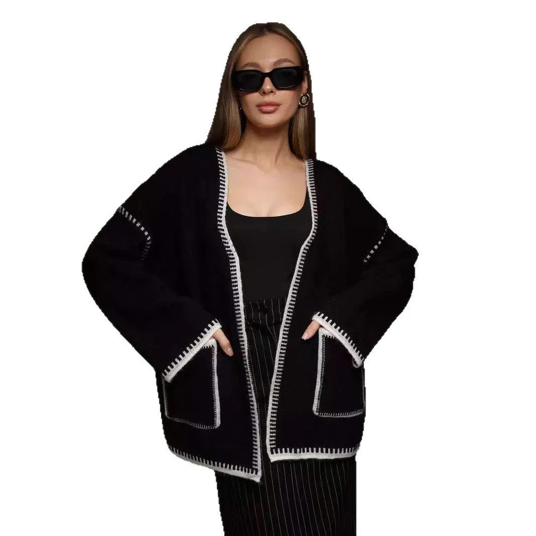 Loose fit camel coloured knitted cardigan sweater with long sleeves laid flat.