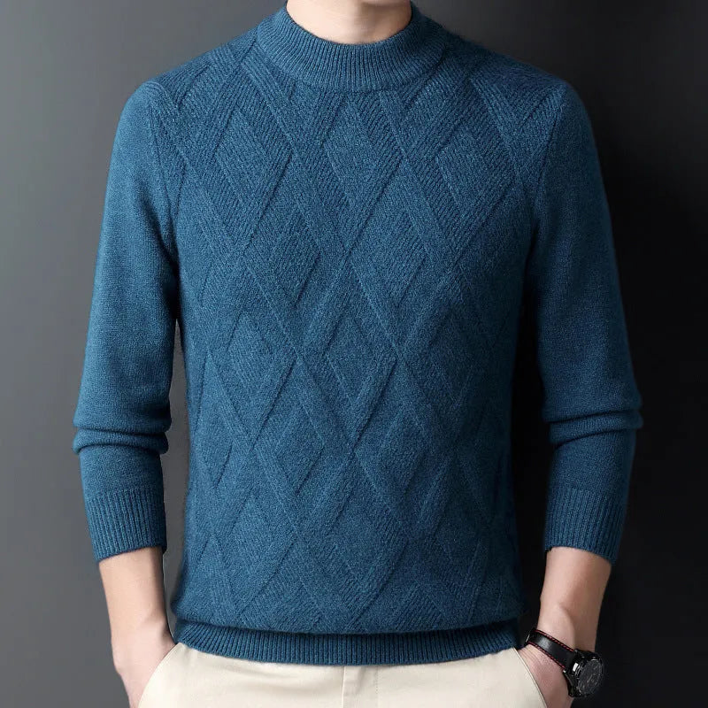 Man wearing a thick grey diamond jacquard knit pullover sweater.
