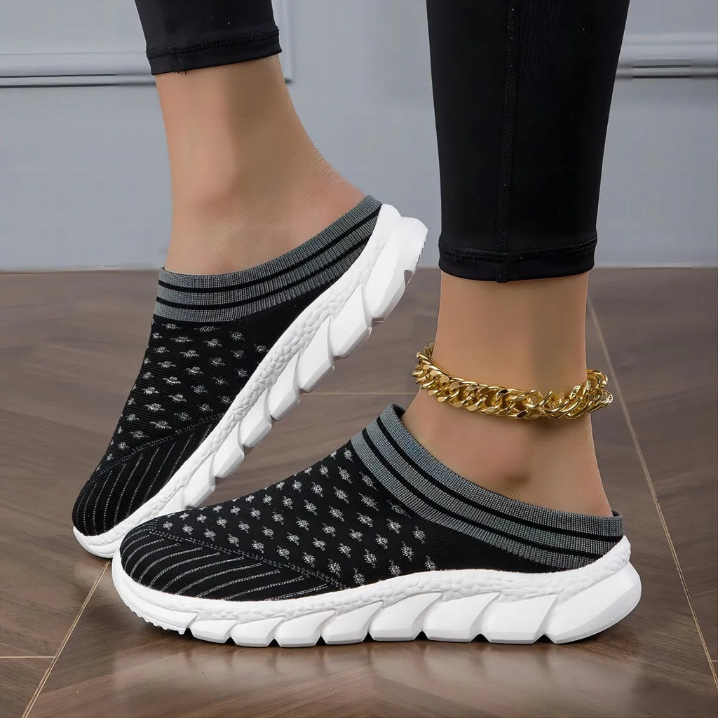Women's black Flyknit casual shoes with striped pattern, hollowed-out design, and sewing lines on a lightweight sole.