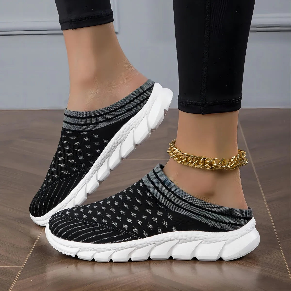 Women's black Flyknit casual shoes with striped pattern, hollowed-out design, and sewing lines on a lightweight sole.