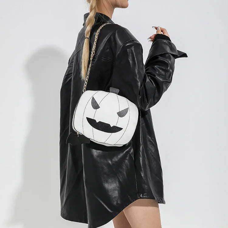 Cartoon pumpkin shoulder bag in orange with chain strap on white background
