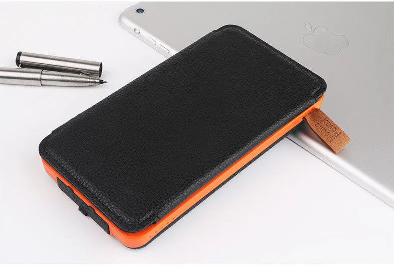 Black solar power bank with leather casing and monocrystalline solar panel showing charging ports and LED light