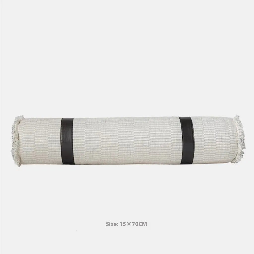 Modern minimalist plaid bed runner set with blanket, pillowcase, and round leather pillow on a bed