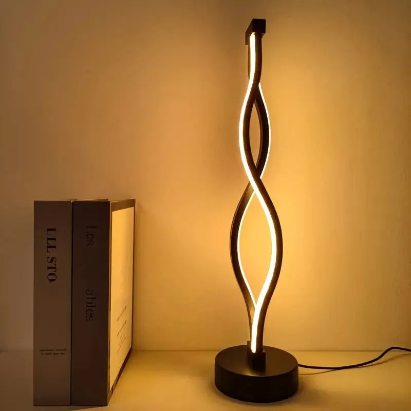 Black aluminium desk lamp with a dimming button and touch controls for blue and pink light