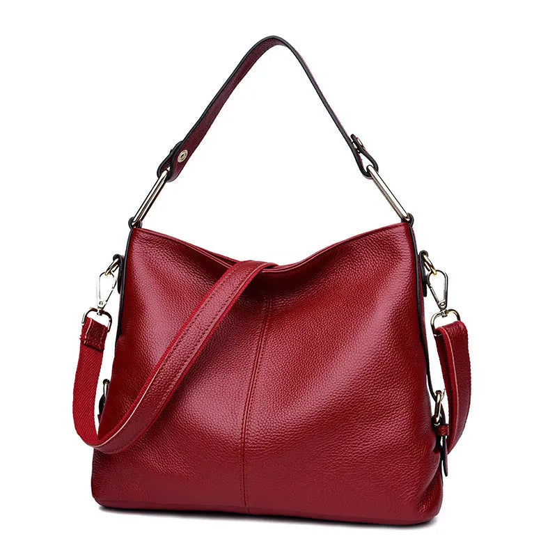 Genuine leather crossbody bag showing vertical square shape and internal compartments for phone and documents