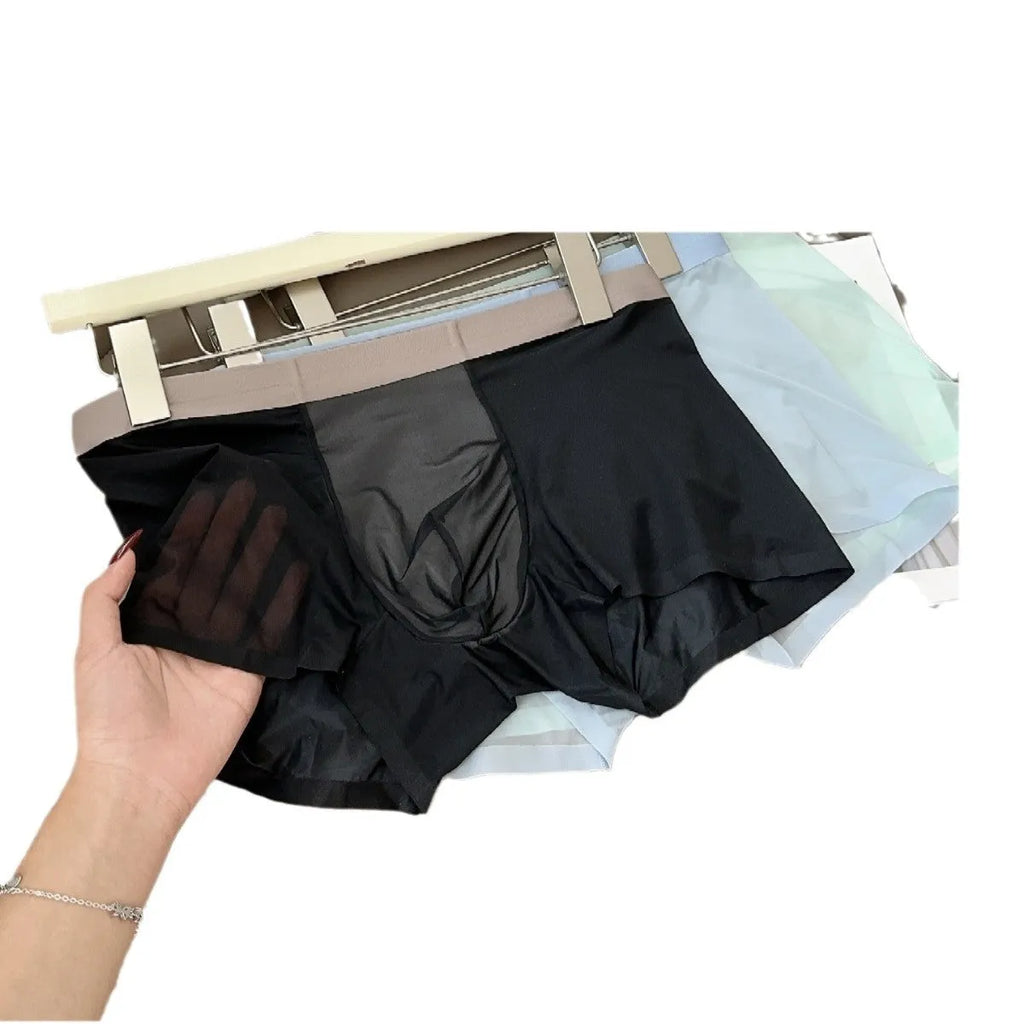Ultra-thin seamless men's boxer shorts showing honeycomb crotch detail in ice silk fabric.