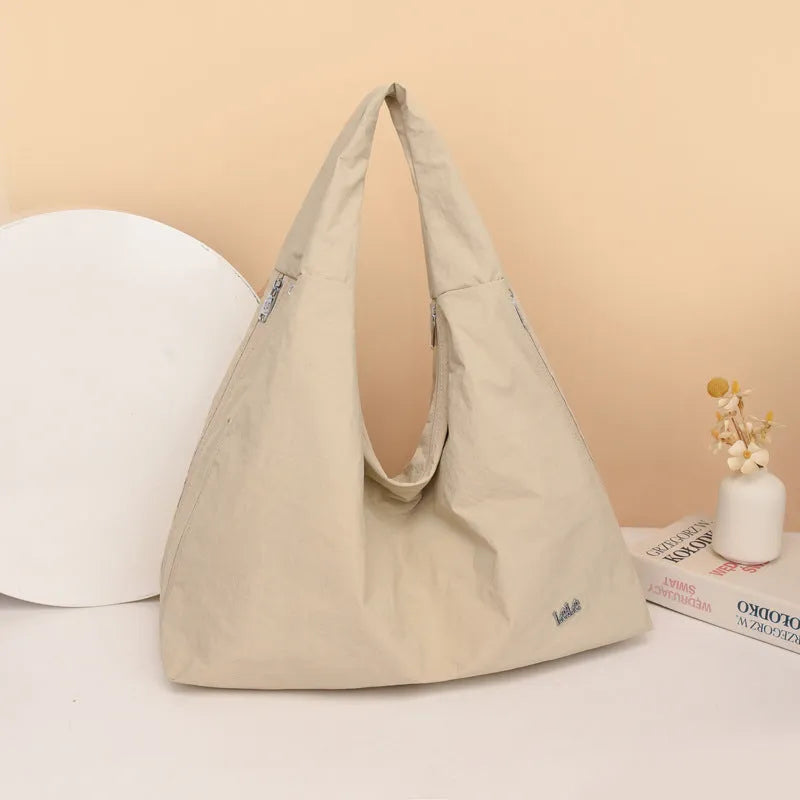 Nylon underarm bag with heart shape design in four colour options showing large capacity interior