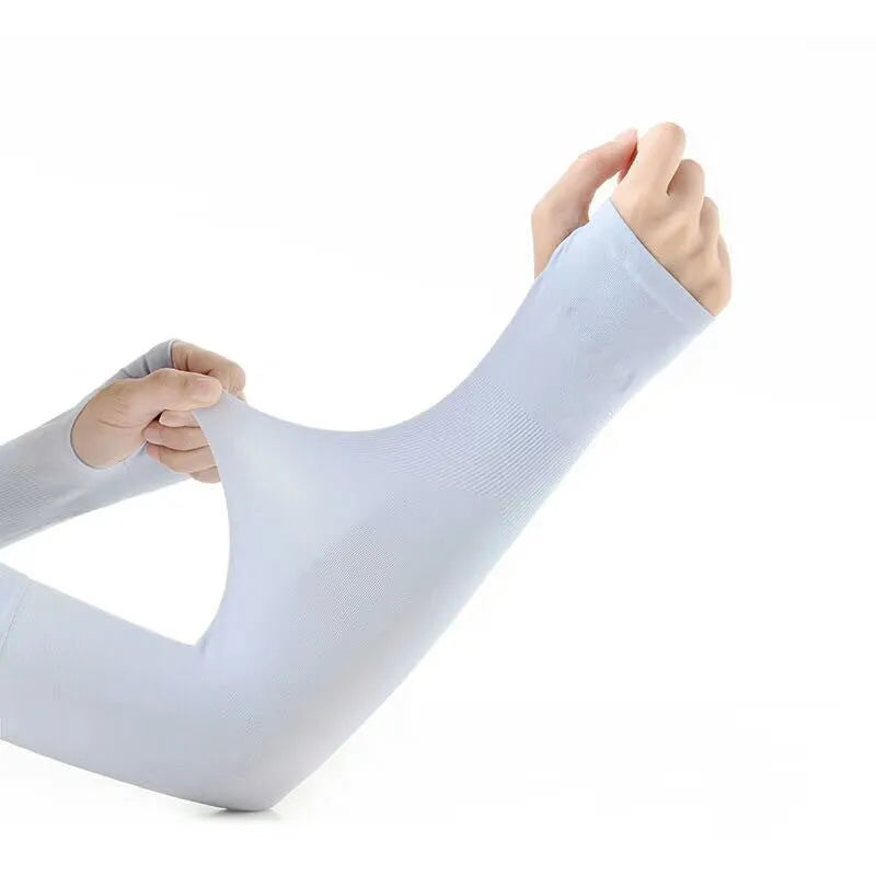 A person wearing a grey sun protection driving sleeve on their forearm, showing the open finger design.