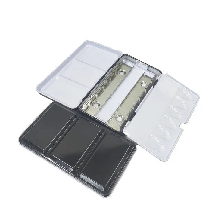Empty square tinplate paint box for solid watercolours with folded compartments.