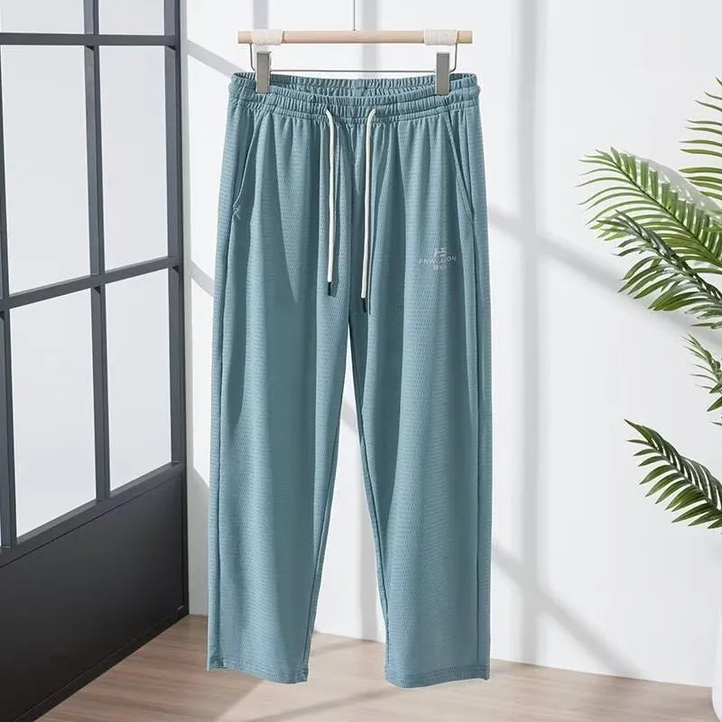 Men's ice silk thin breathable quick-drying casual pants in black, loose straight-leg style with drawstring waist