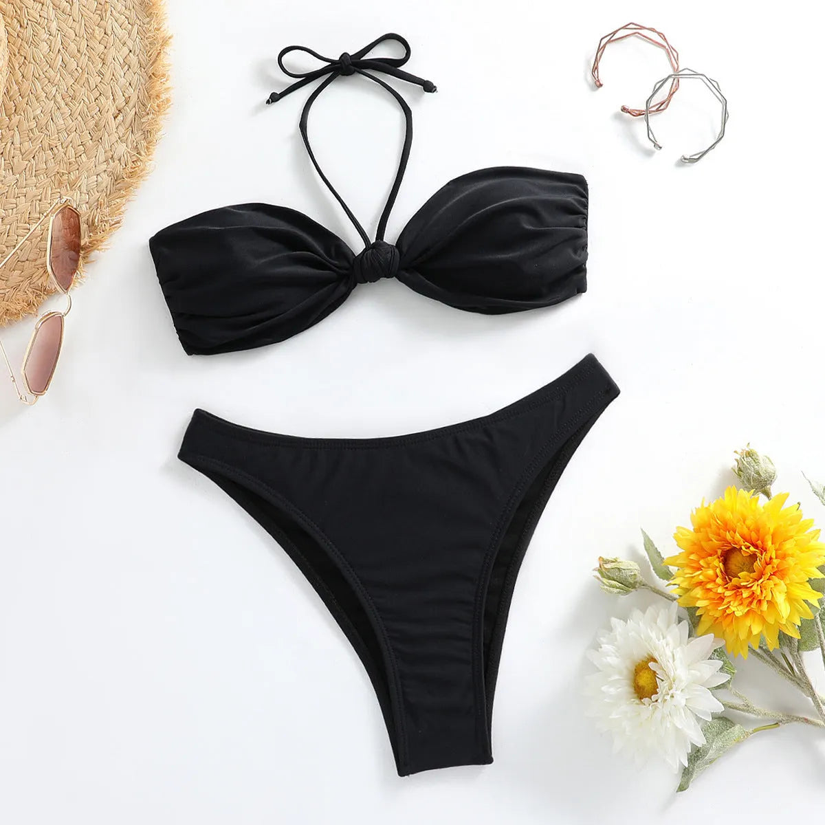 Black women's bikini set with lace-up tube top and matching briefs on swimwear hanger