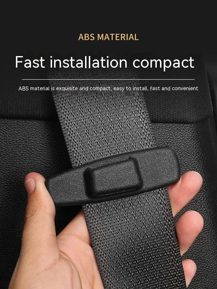Two black ABS plastic car seat belt stopper clips on vehicle seat