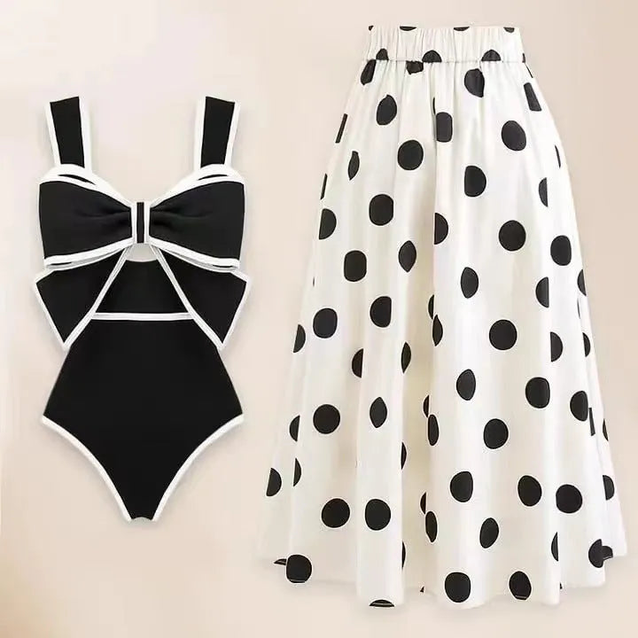 Women's black one-piece swimsuit with white attached skirt beach dress and bow trim