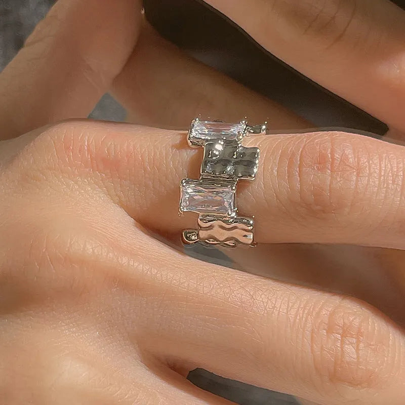 Geometric cross zircon ring in silver-plated metal with open design and three-dimensional decoration