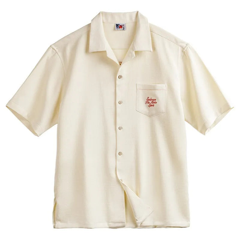 Light apricot men's shirt with bamboo plant print and a Cuban collar on a hanger