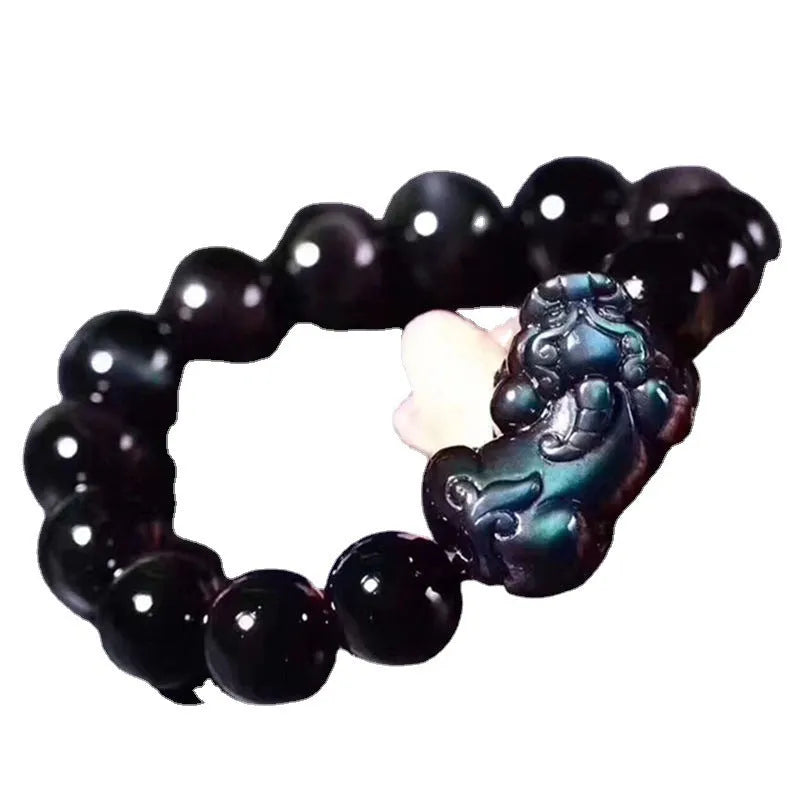Natural ice colour Eye Obsidian crystal beaded bracelet on a wrist, showing round beads.