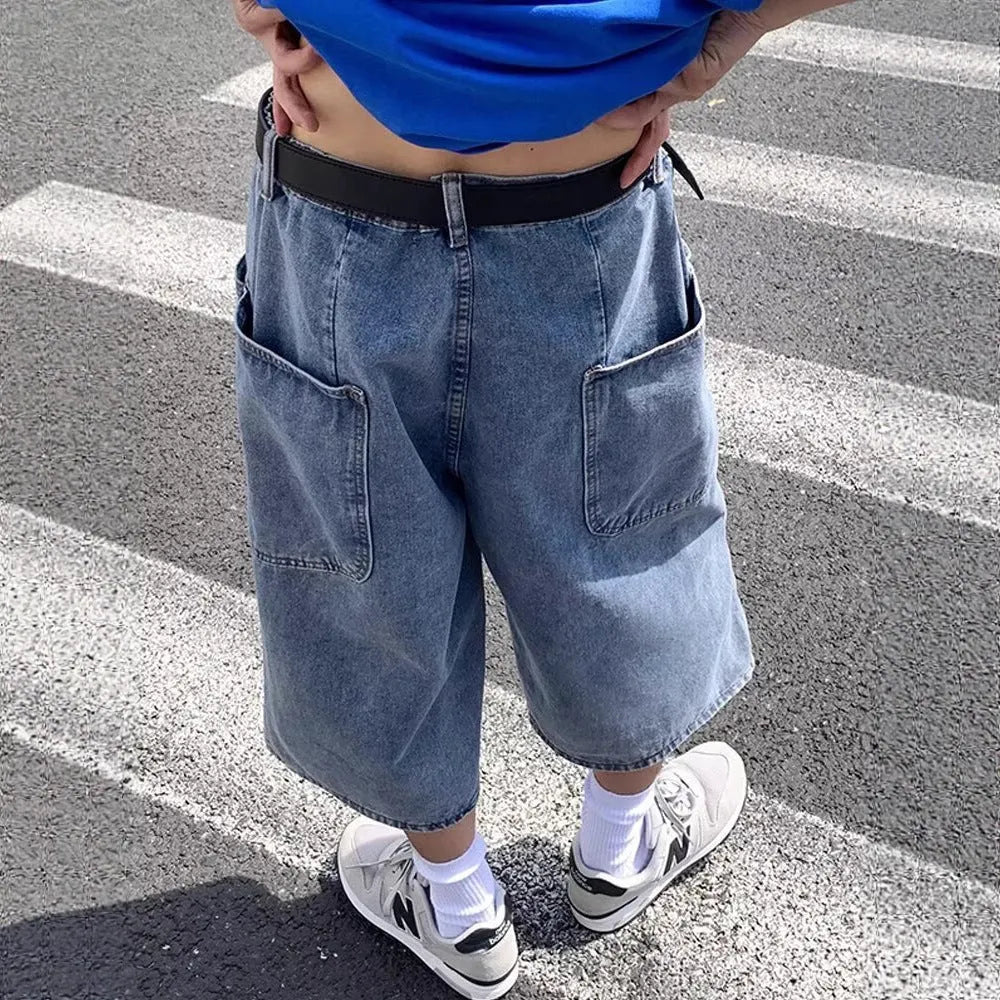 Men's washed blue denim pirate shorts with high waist and cropped straight legs on a plain background