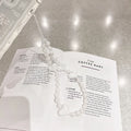 Clear transparent iPhone case with a raised 3D ice-effect bow design on the back.