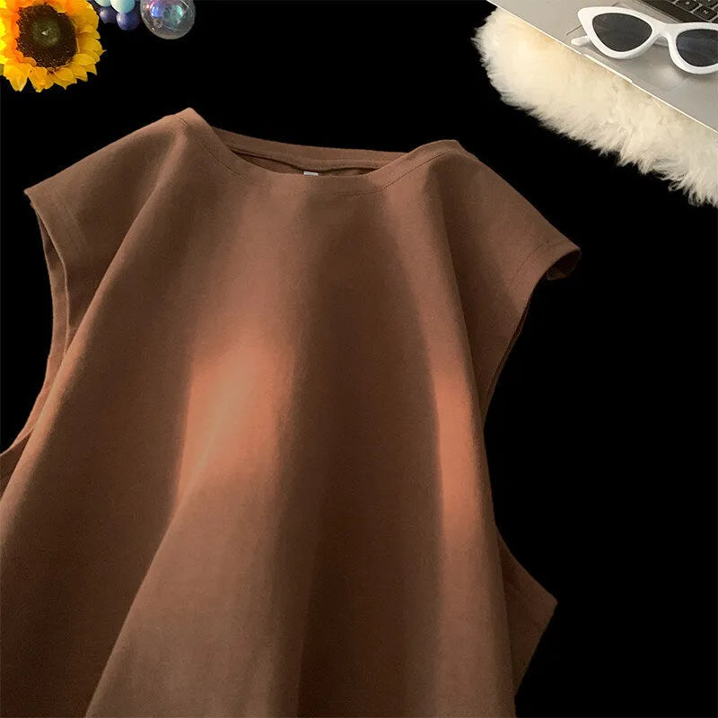 Men's loose solid colour sleeveless cotton tank top on a hanger, shown in a light apricot shade.
