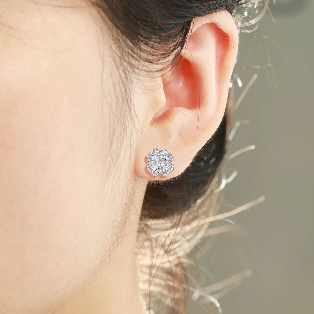 Pair of heart-shaped sterling silver stud earrings with a four-leaf clover design and a central zircon stone.