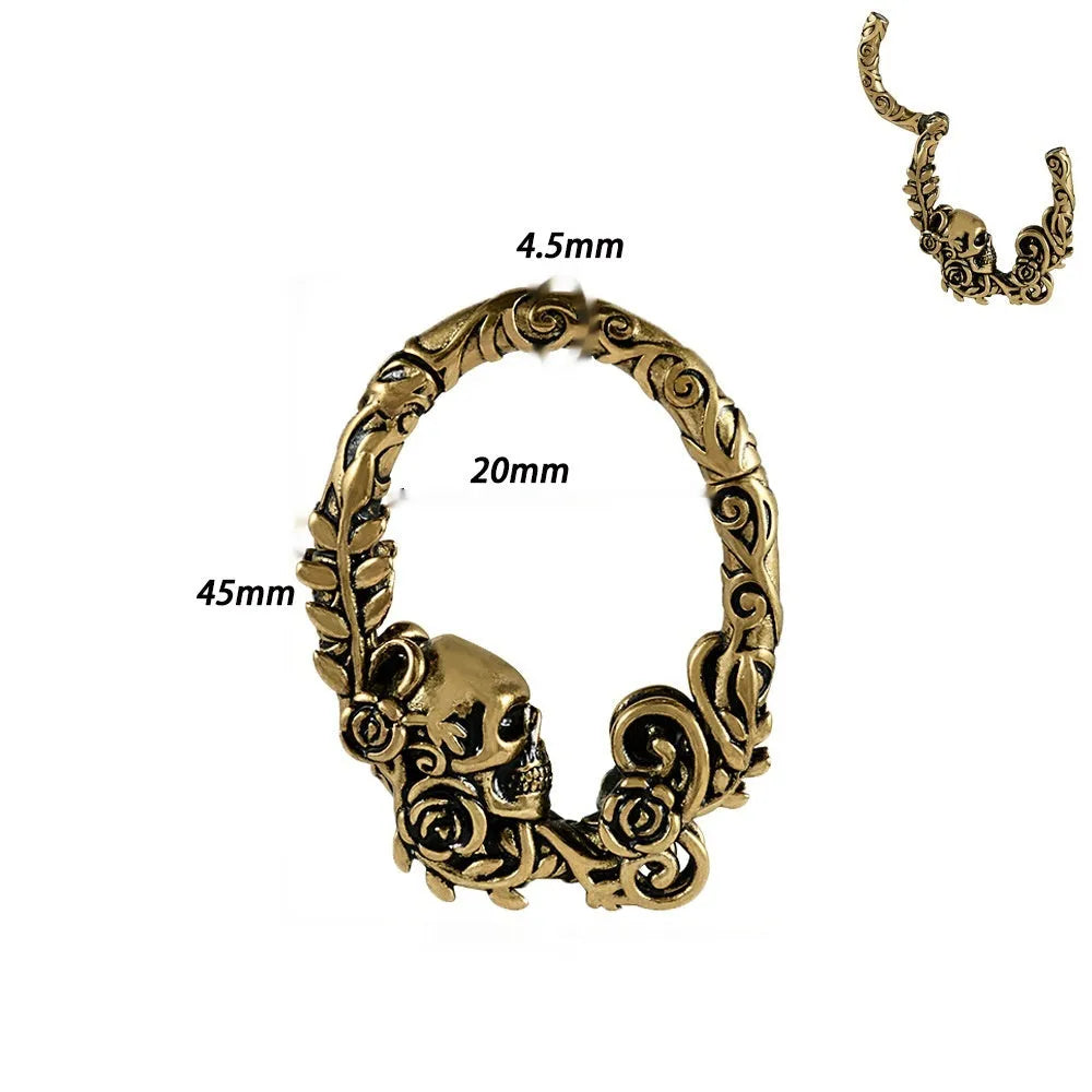 A pair of geometric cone and round shaped copper ear cuffs with magnetic clip-on fasteners.