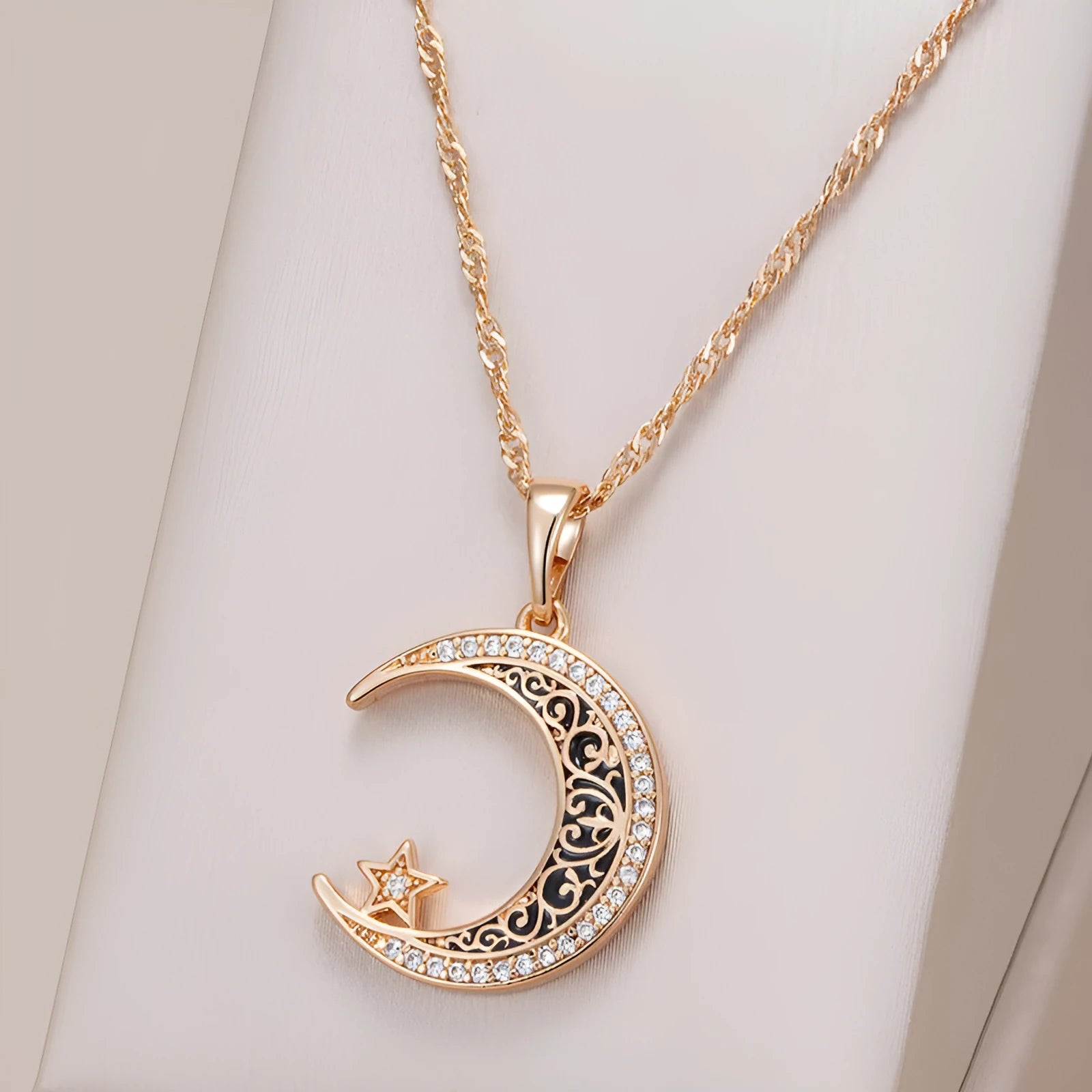 Rose gold star and moon necklace with zircon pendant on a water wave chain.