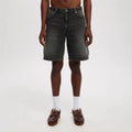 Man wearing loose fit light blue straight leg denim jeans, a streetwear summer style.
