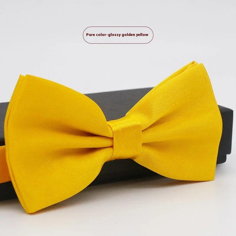 Men's flat head style polyester bow tie in a solid colour, shown with adjustable neck strap.