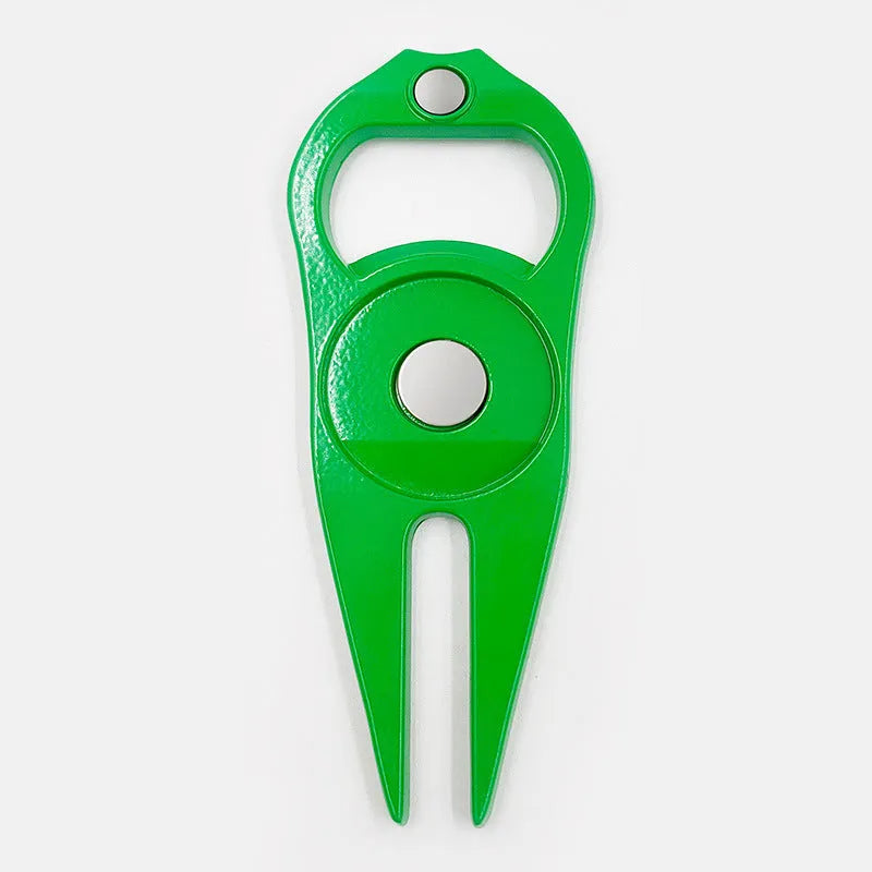 Black zinc alloy golf ball yoke fork with integrated bottle opener tool on green turf.