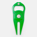 Black zinc alloy golf ball yoke fork with integrated bottle opener tool on green turf.