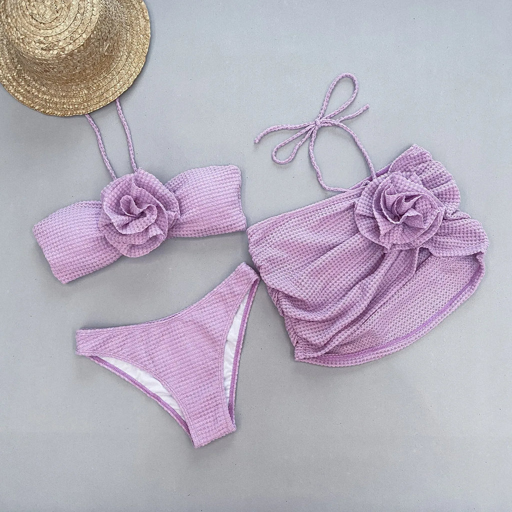 Women's purple and white 3D flower split three-piece bikini set with skirt, bra, and briefs.