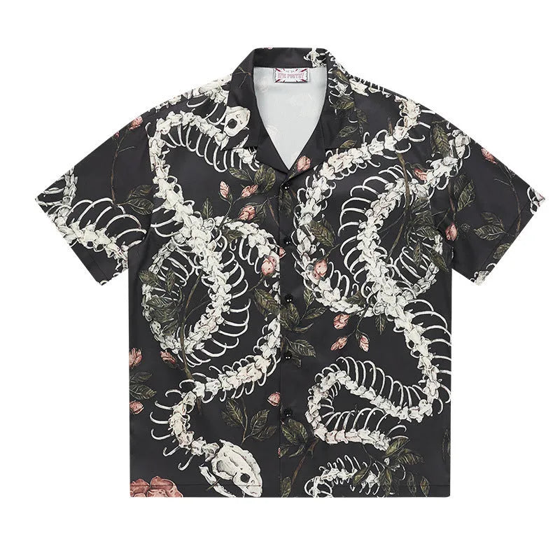 Short sleeve loose-fit shirt with a Cuban collar and a printed snake bone floral pattern.