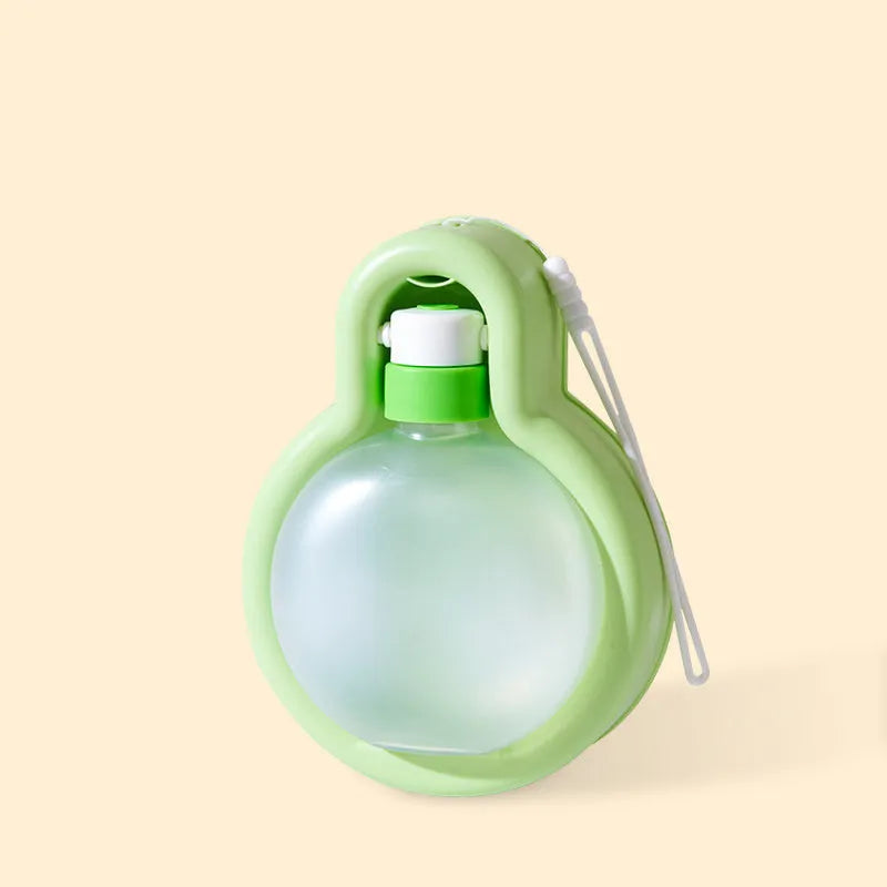 Green portable dog travel water bottle with integrated drinking bowl dispenser.