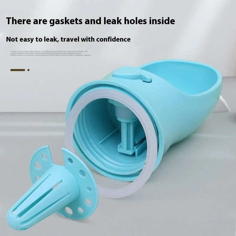 A blue portable plastic dog water bottle with an integrated flip-out drinking bowl on a green background.