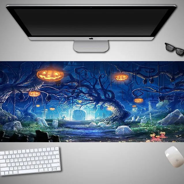 Oversized black Halloween-themed mouse pad with spooky artwork on a desk next to a gaming mouse.