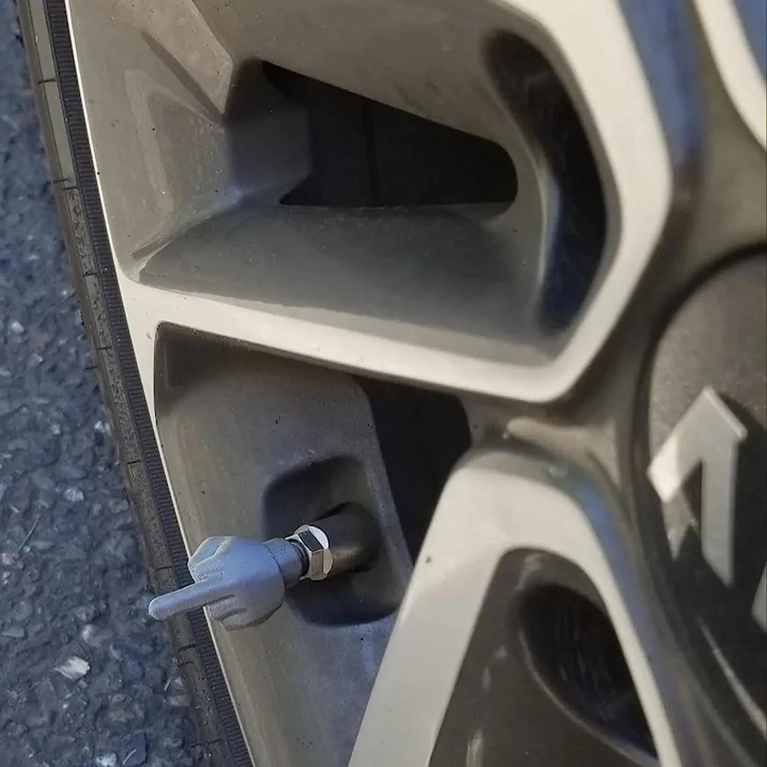 Four latex tyre valve dust caps showing black and skin colour pieces for car wheel valve protection