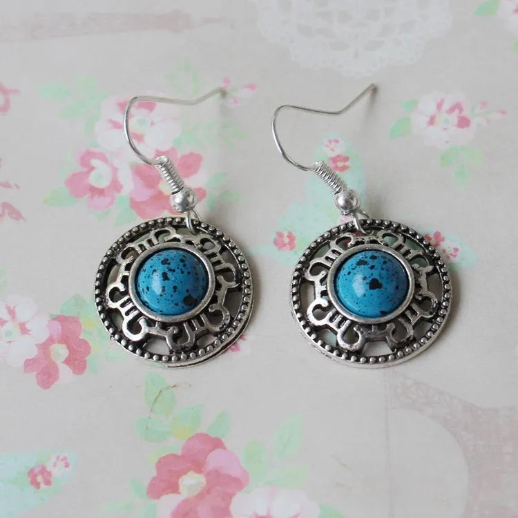 Handmade Miao silver ethnic earrings with turquoise stones in geometric flower disk design