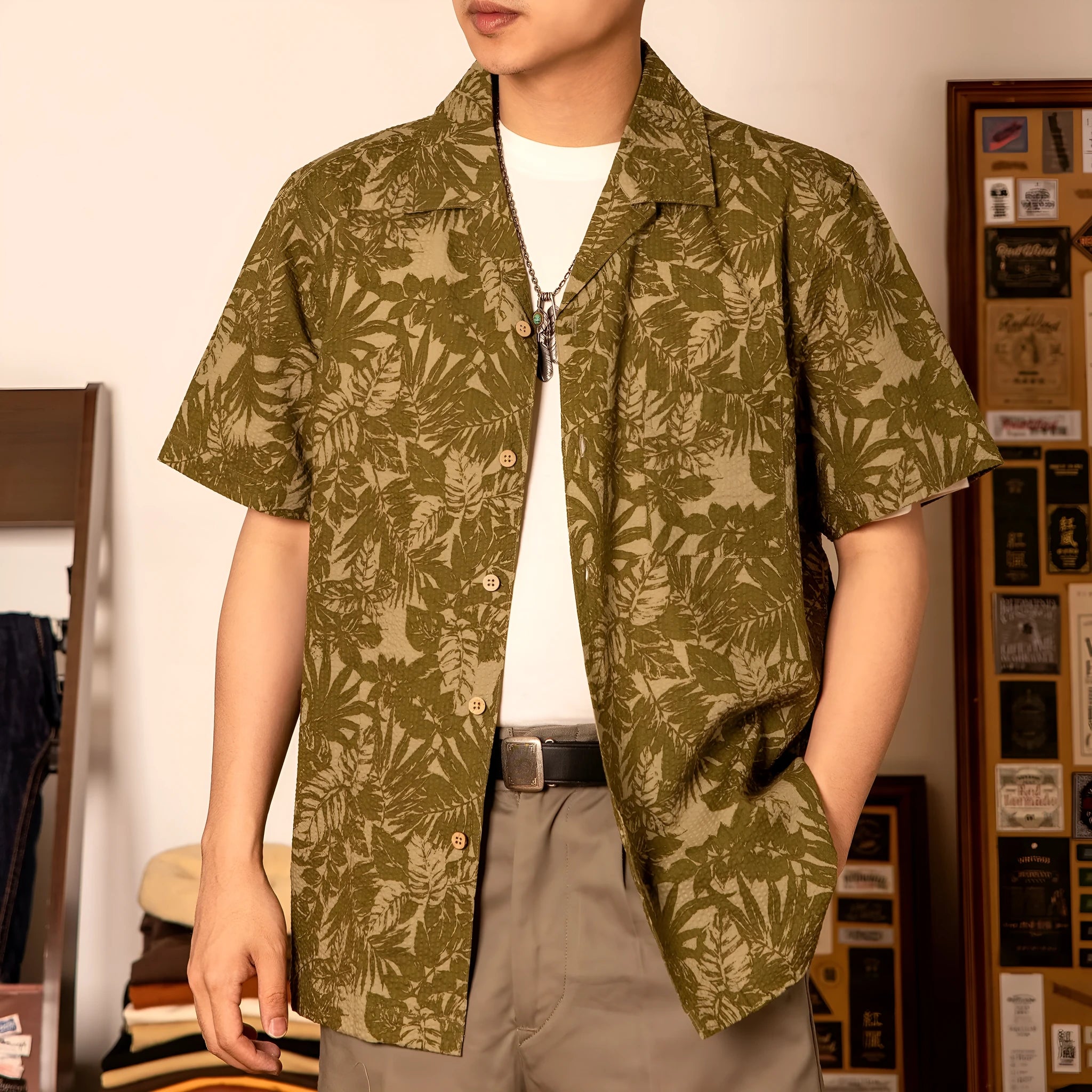 Man wearing a vintage green seersucker shirt with floral print and a Cuban collar.
