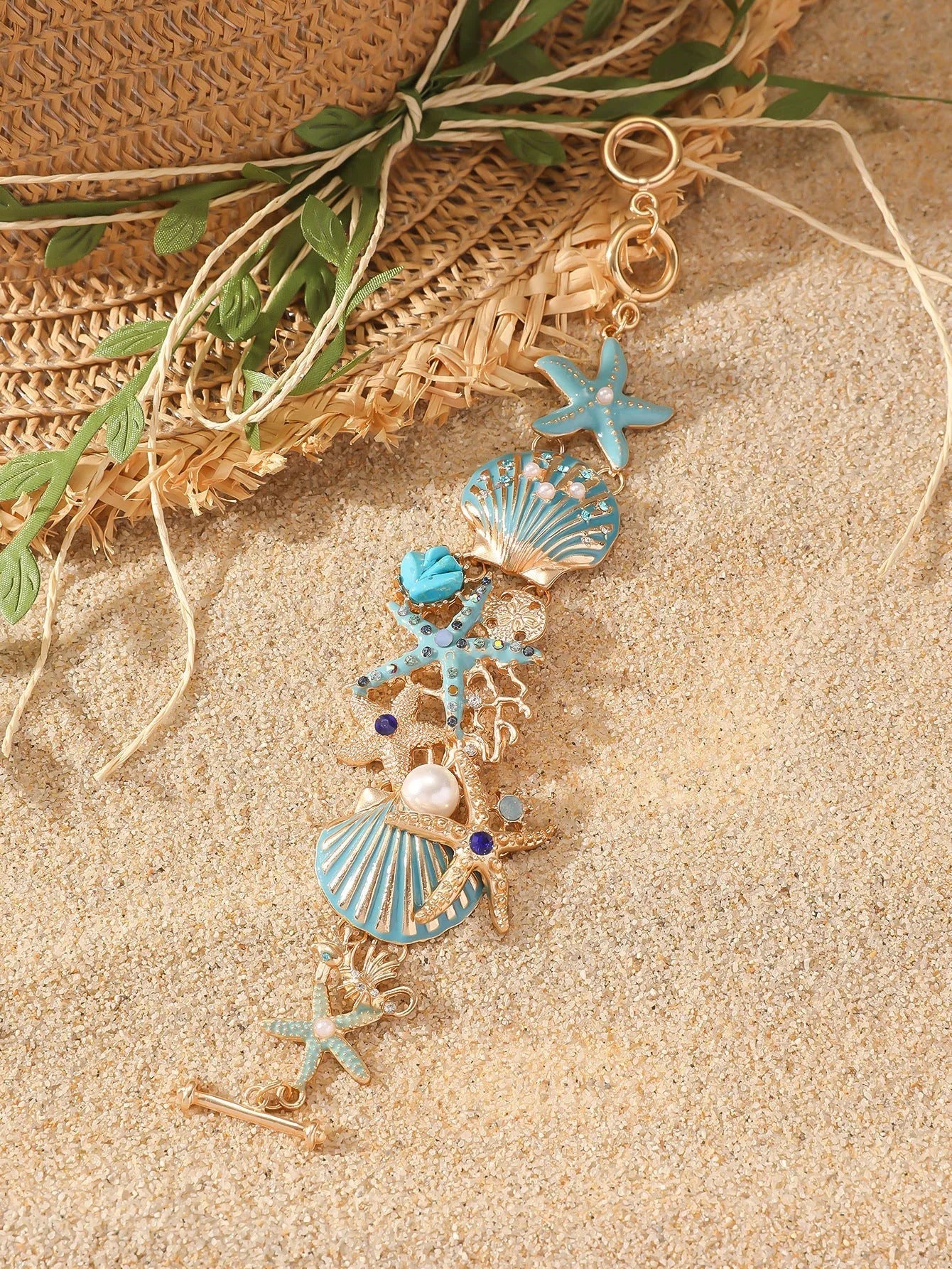 Women's alloy bracelet with a rhinestone-studded boat anchor and starfish charm in blue, red, or turquoise.