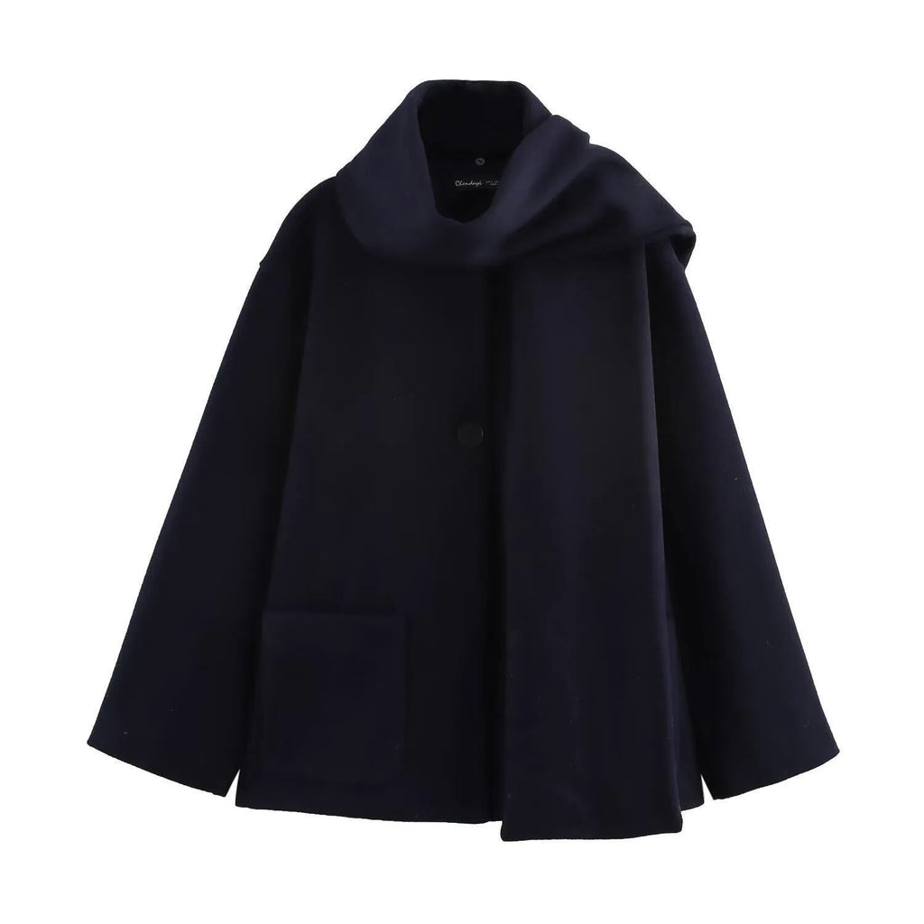 Women's long black polyester coat with a fluffy artificial fur collar, side pockets, and a street-fashion silhouette.