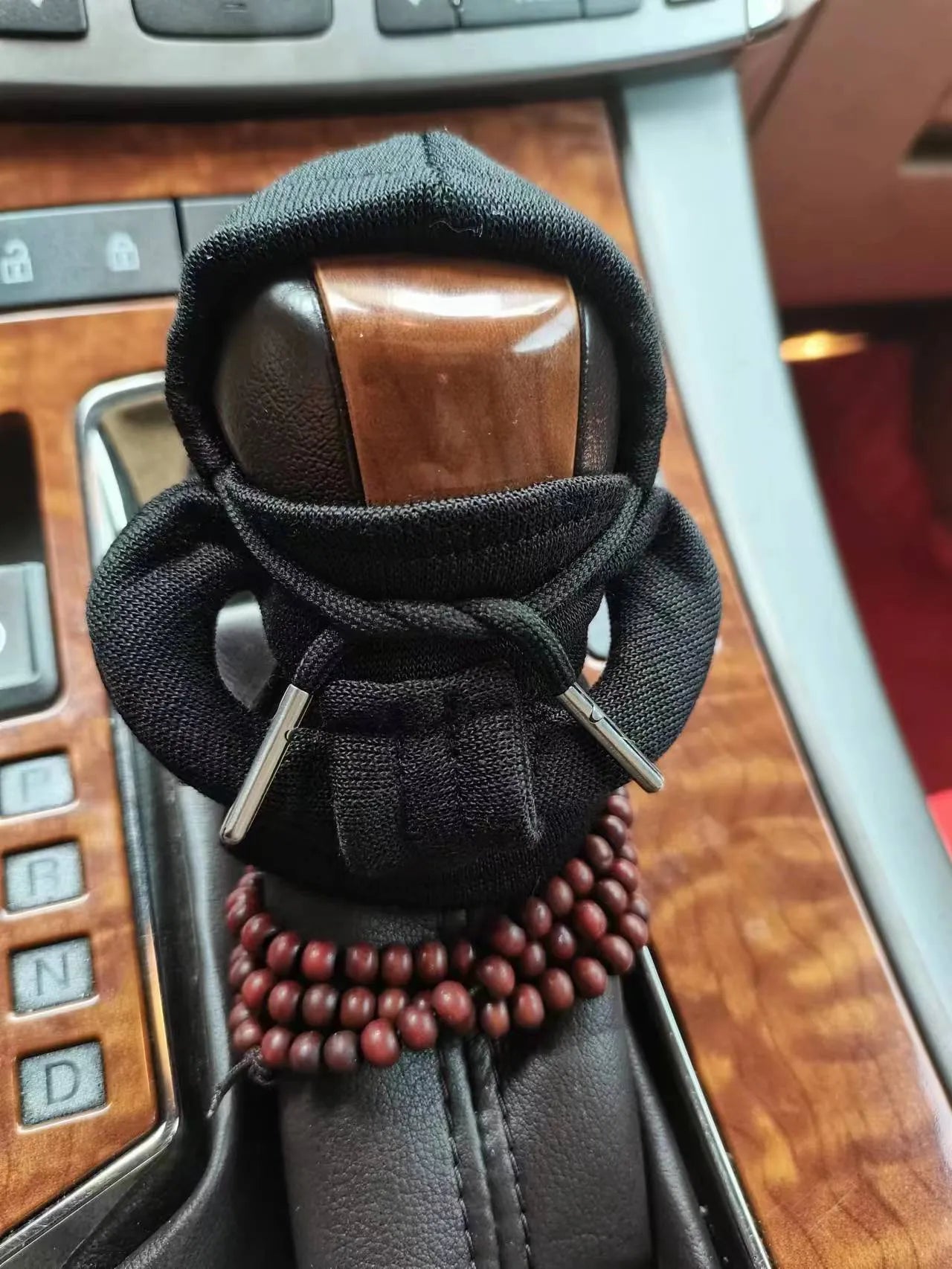 Dutch velvet car gear handle sleeve cover in multiple colours on a car gear lever.