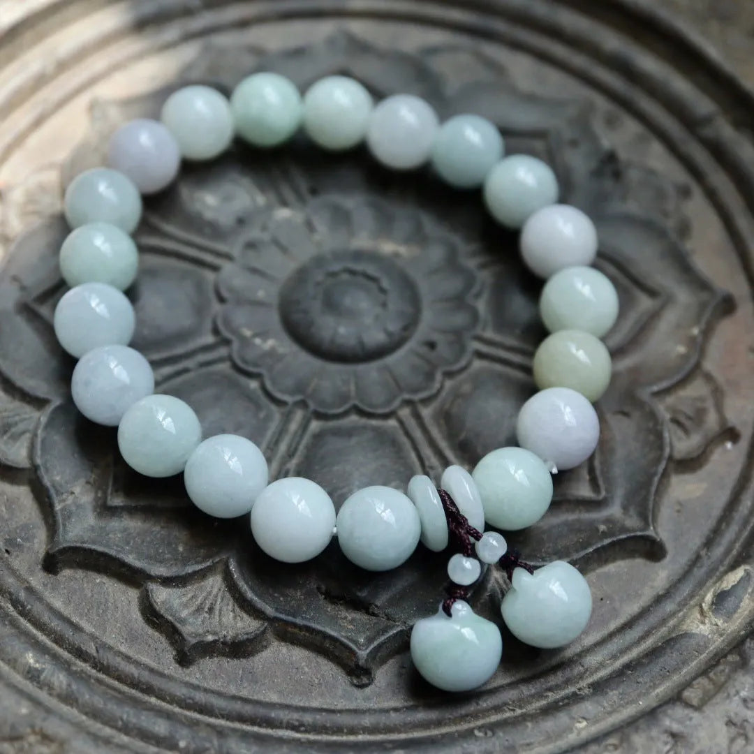 Natural green jade bracelet with geometric links and a carved Maitreya Buddha pendant.