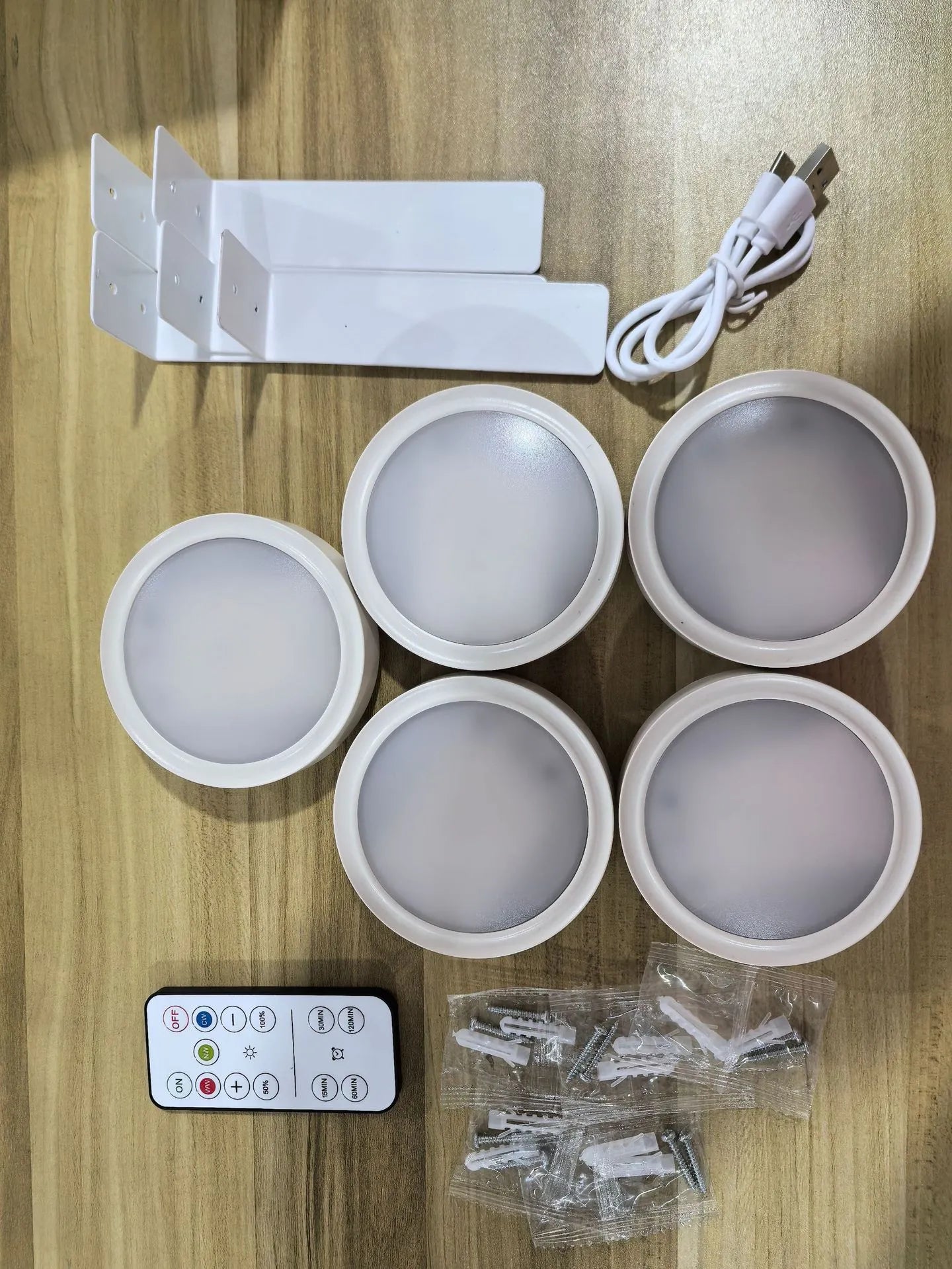 Wireless rechargeable LED painting lamp with magnetic belt attached to a metal frame, remote control nearby.