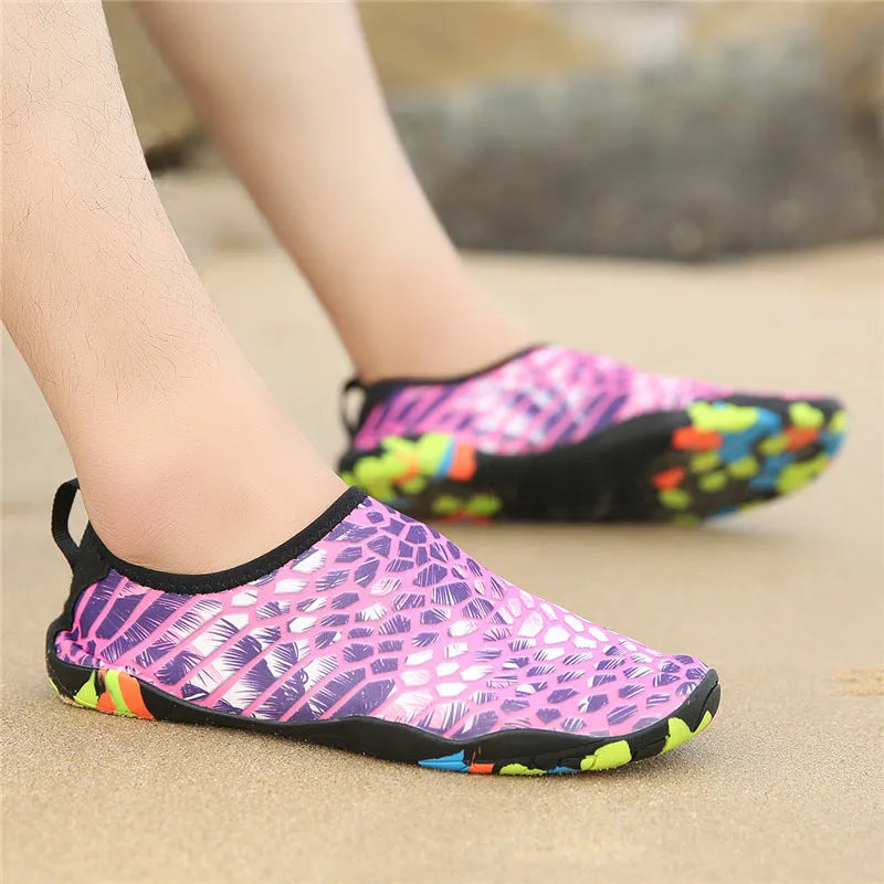 Blue Lycra beach wading shoes with EVA midsole on a sandy beach