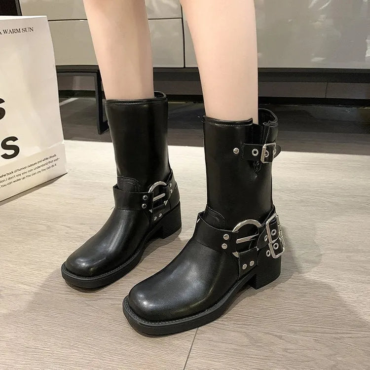 Women's black platform boot with belt buckle detail on middle calf.